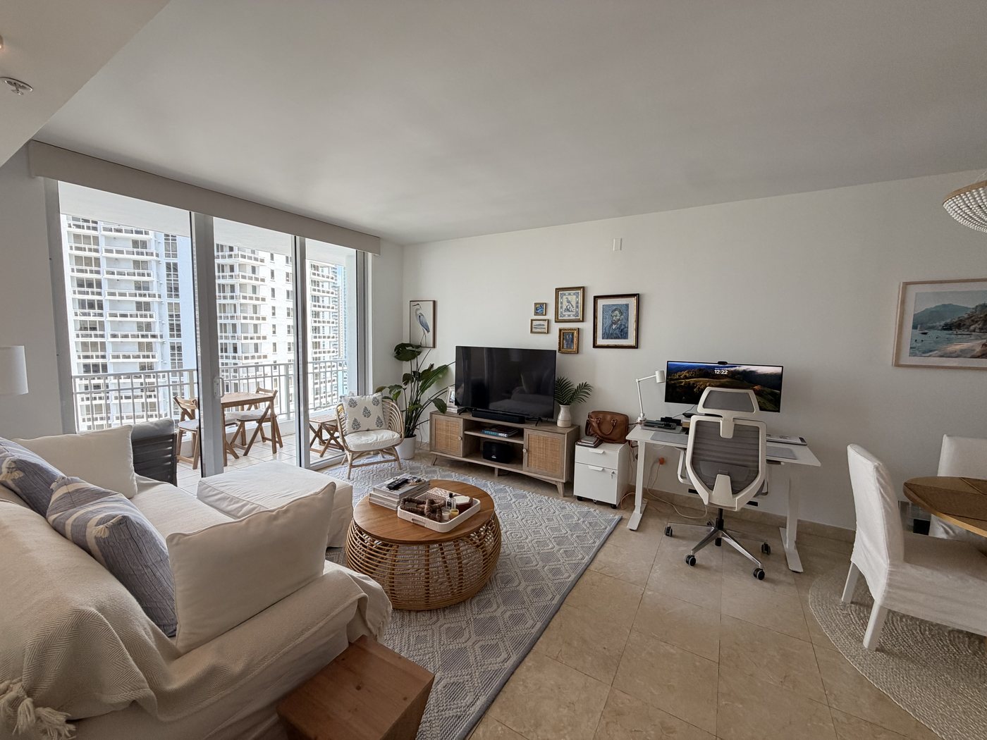 Living room furnished with sofa, rug, and workspace
