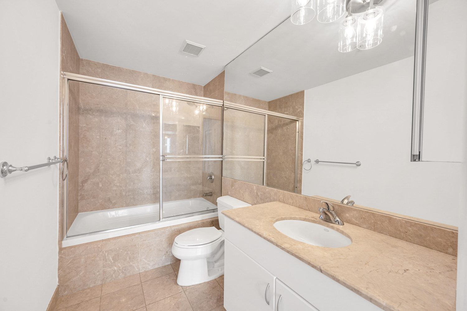 Bathroom with soaking tub, glass shower doors, and vanity