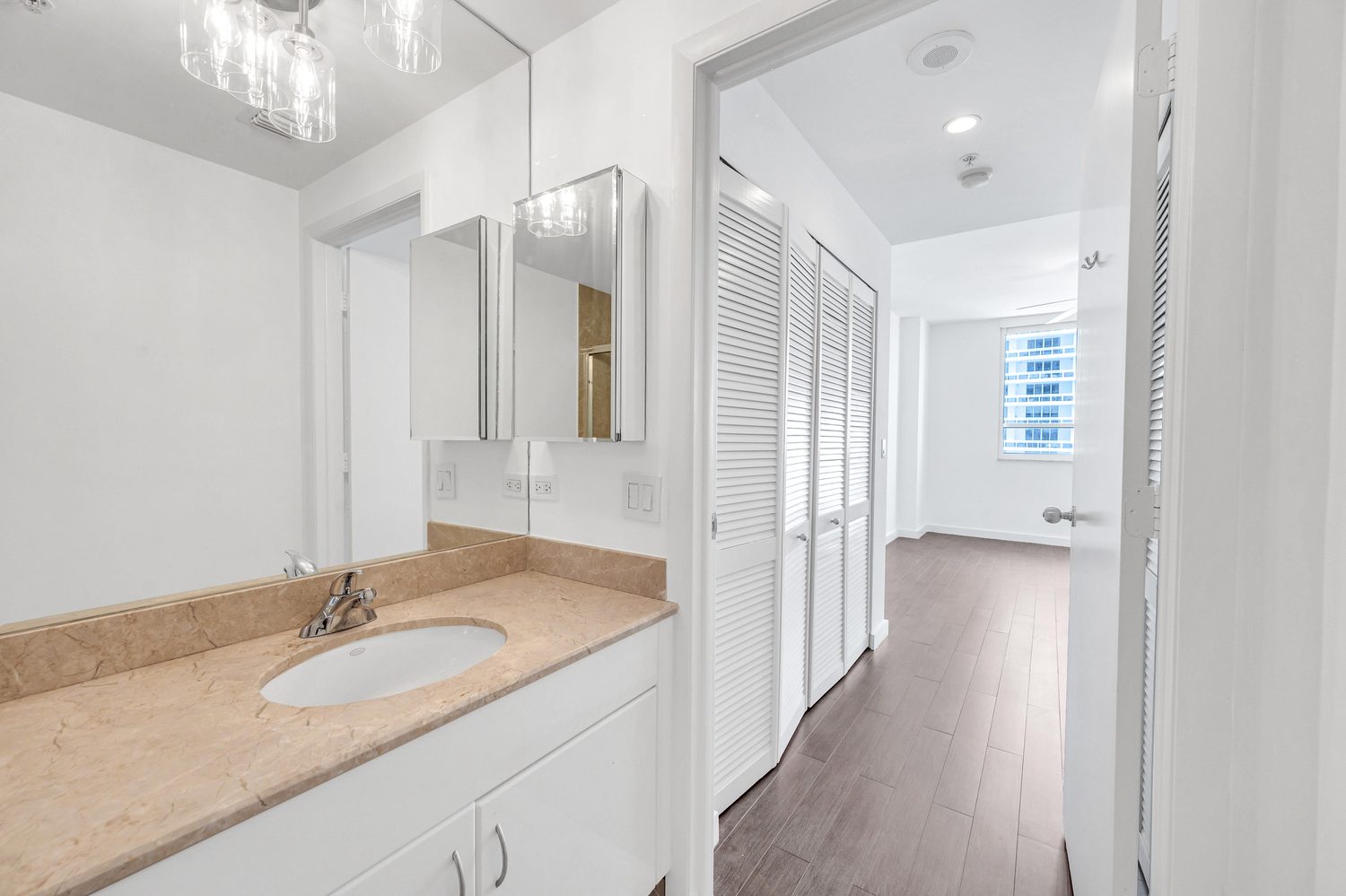 Bathroom vanity and mirror, hallway toward the bedroom