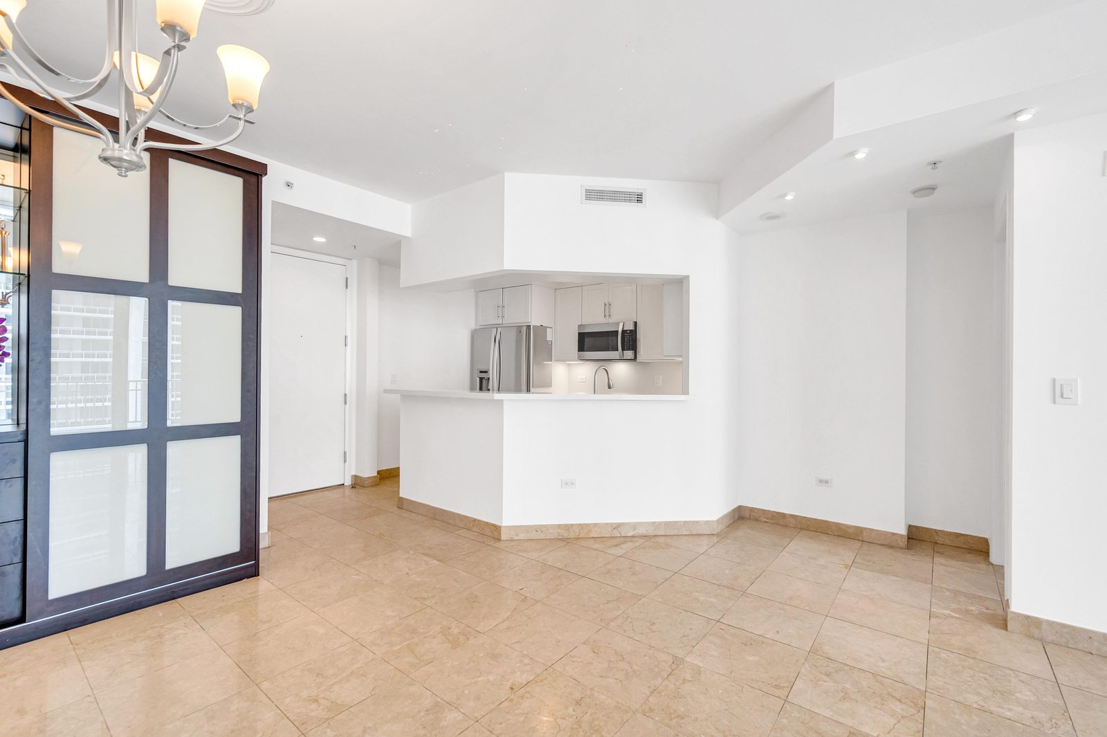Living room with balcony access and built-in shelving